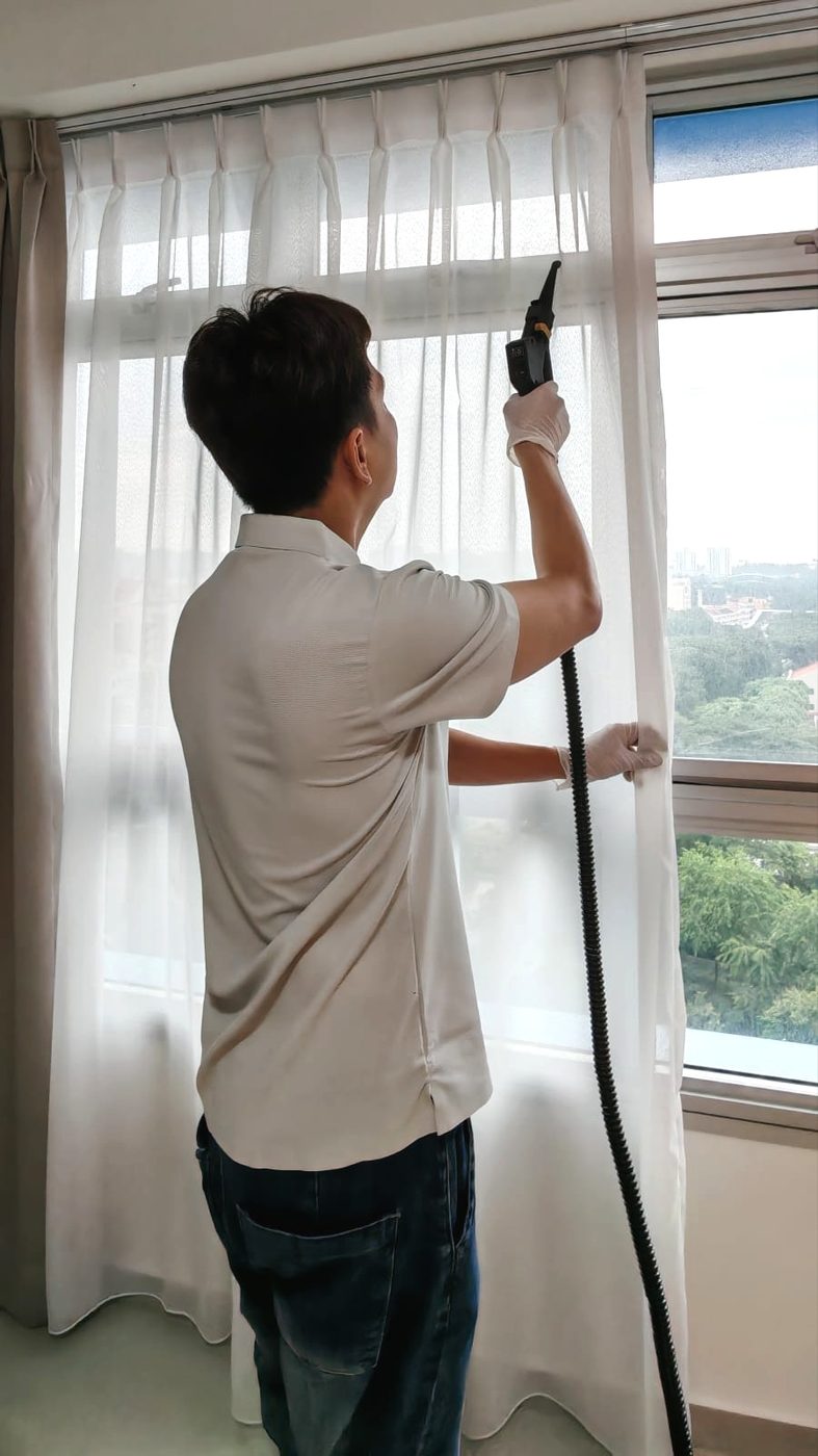 UltraRevive technician cleaning sheer curtains in a Singapore home