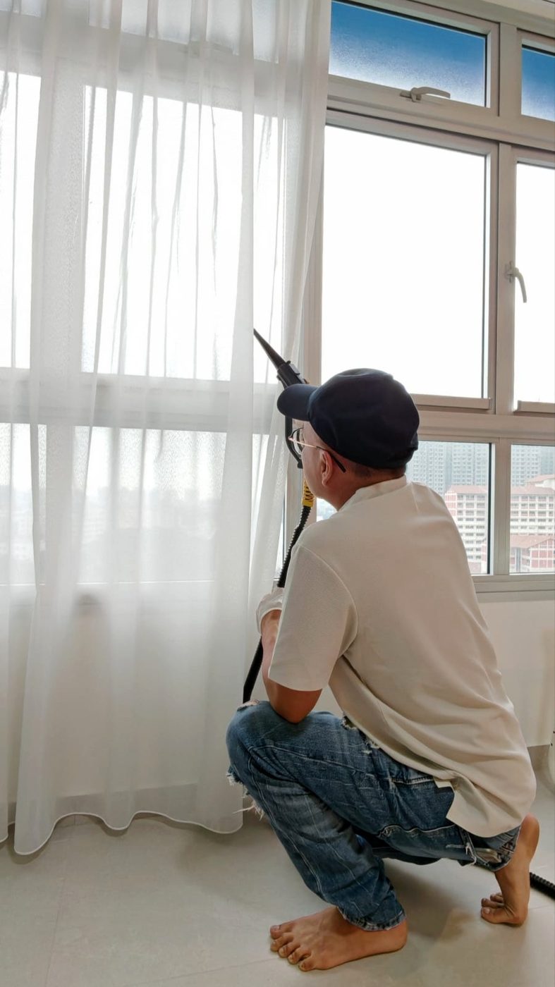 UltraRevive technician refreshing full-length curtains in Singapore
