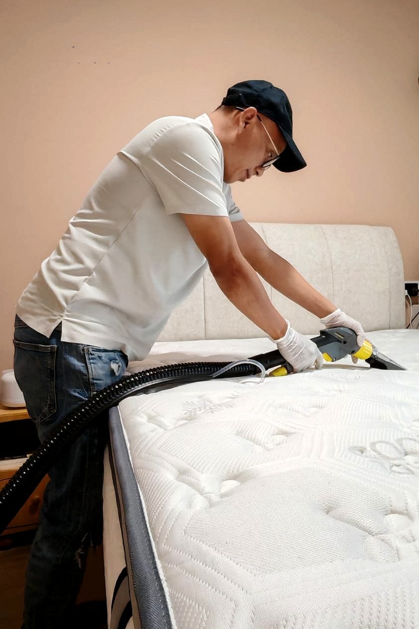 UltraRevive technician extraction-cleaning a mattress surface in Singapore